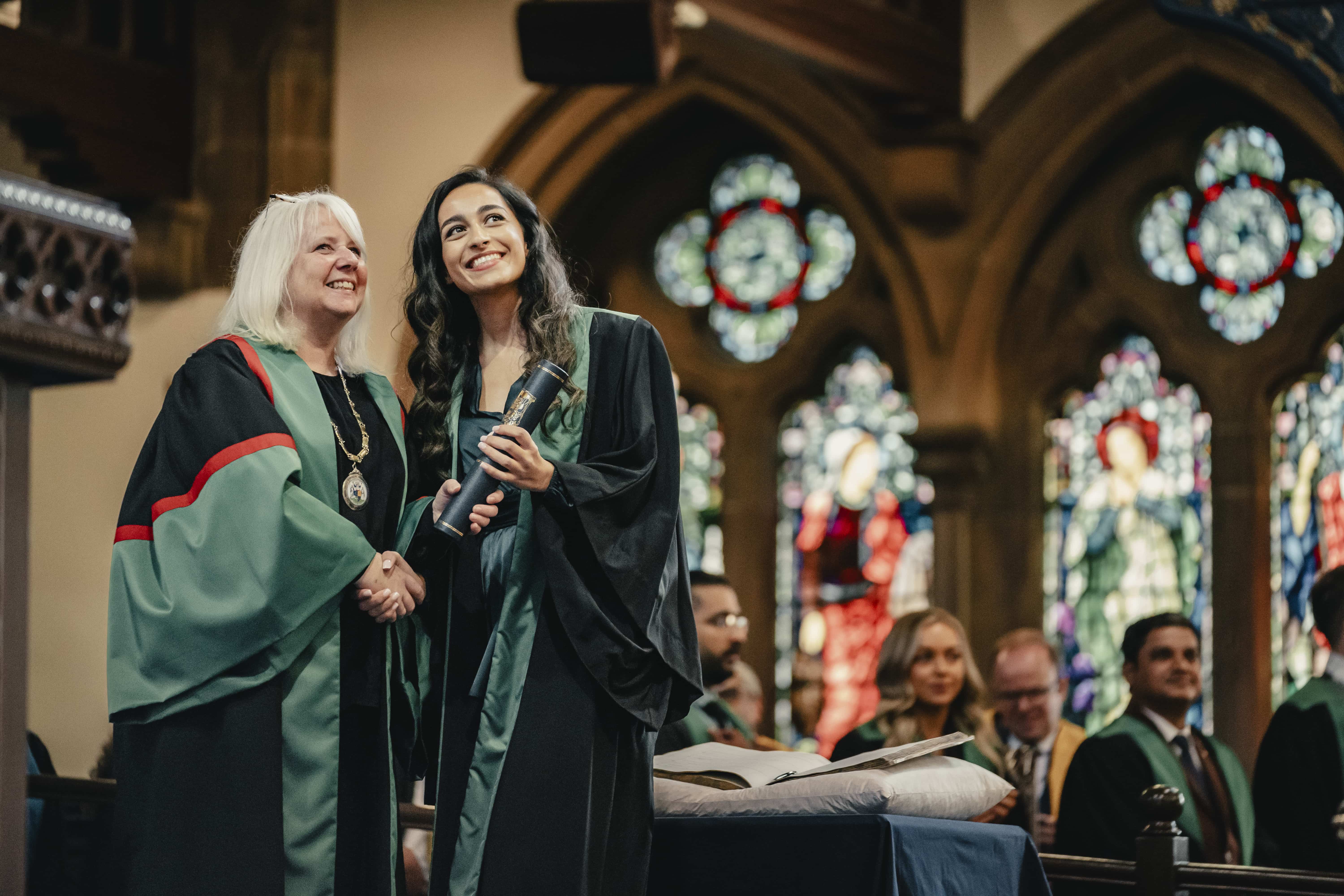 Two women in a church in robes